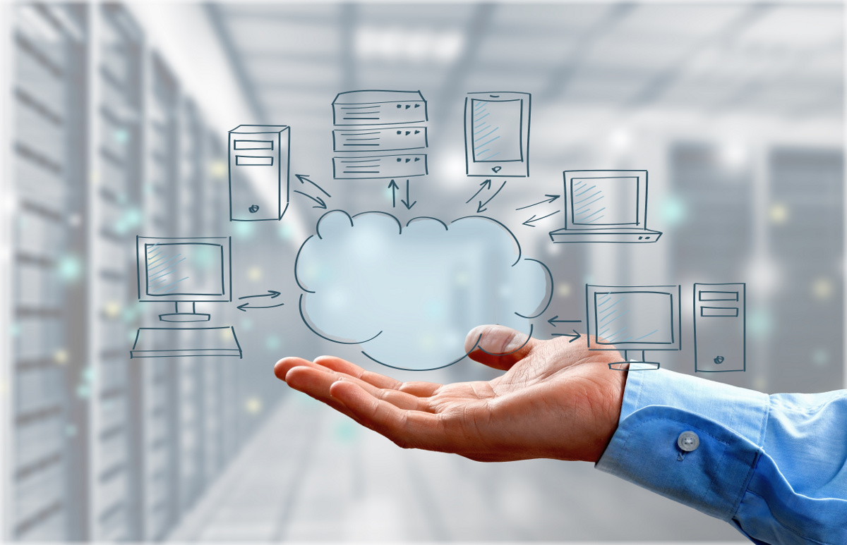 Businessman Holding Hosted Cloud Solution Concept Image in Hand with Data Center Background