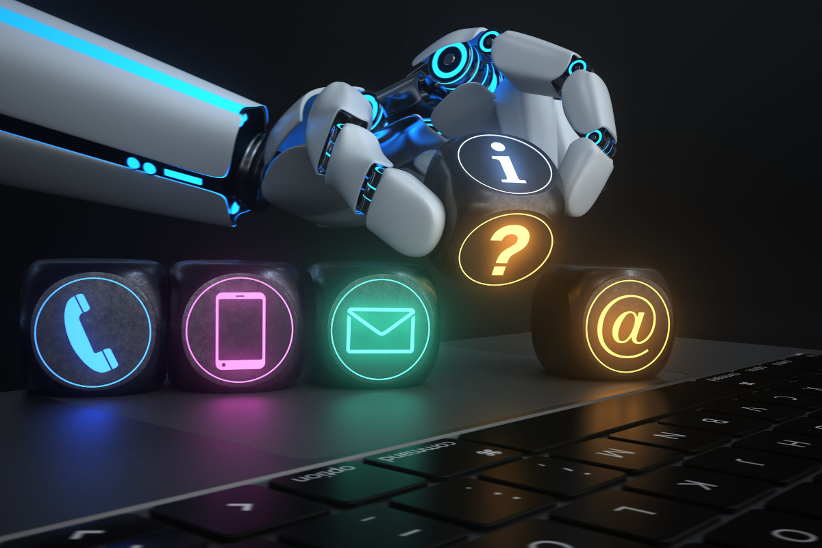 Robotic hand placing glowing cubes with phone, mail, and web icons on a keyboard
