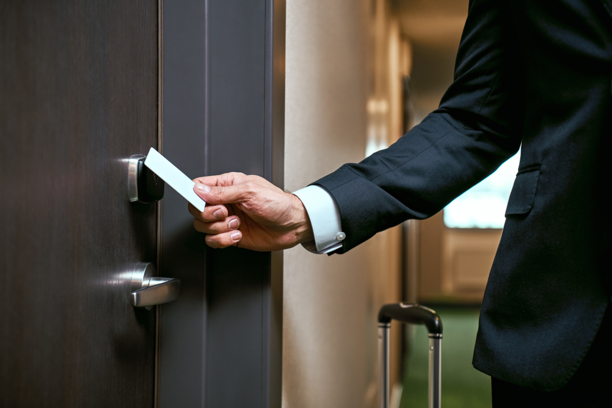 A person using a key-card to open a locked door