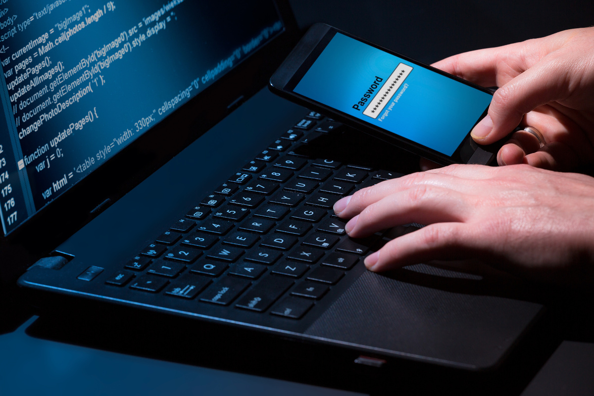 Man using mobile phone and computer and needs to input password