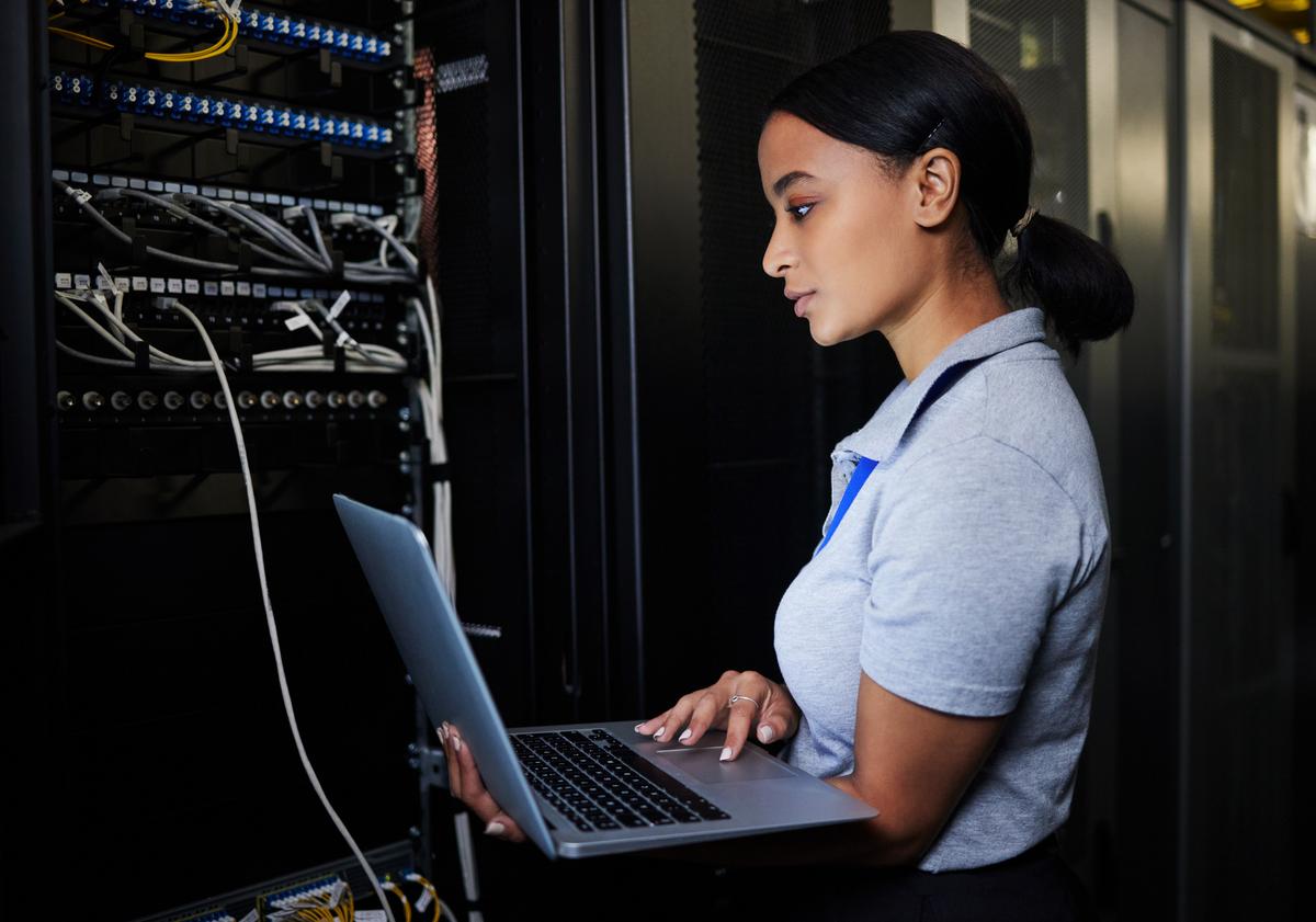 Women checking things in server room