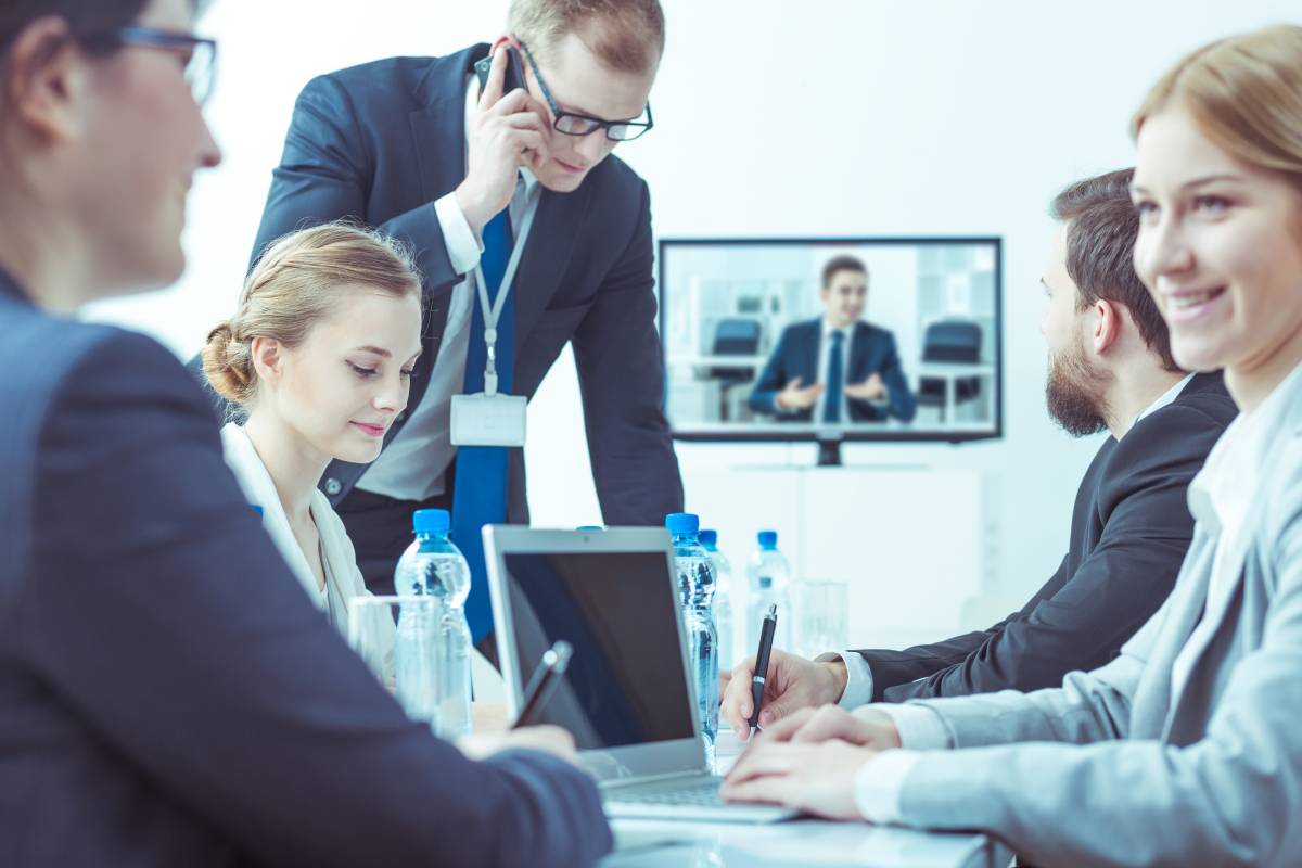 Business people collaborating in a professional setting and video conferencing with colleague