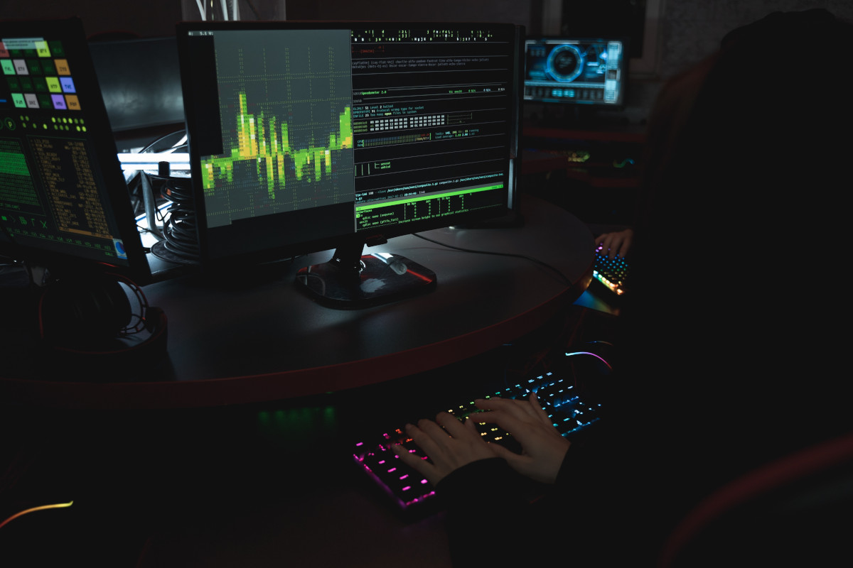 Man in shadows working on computers