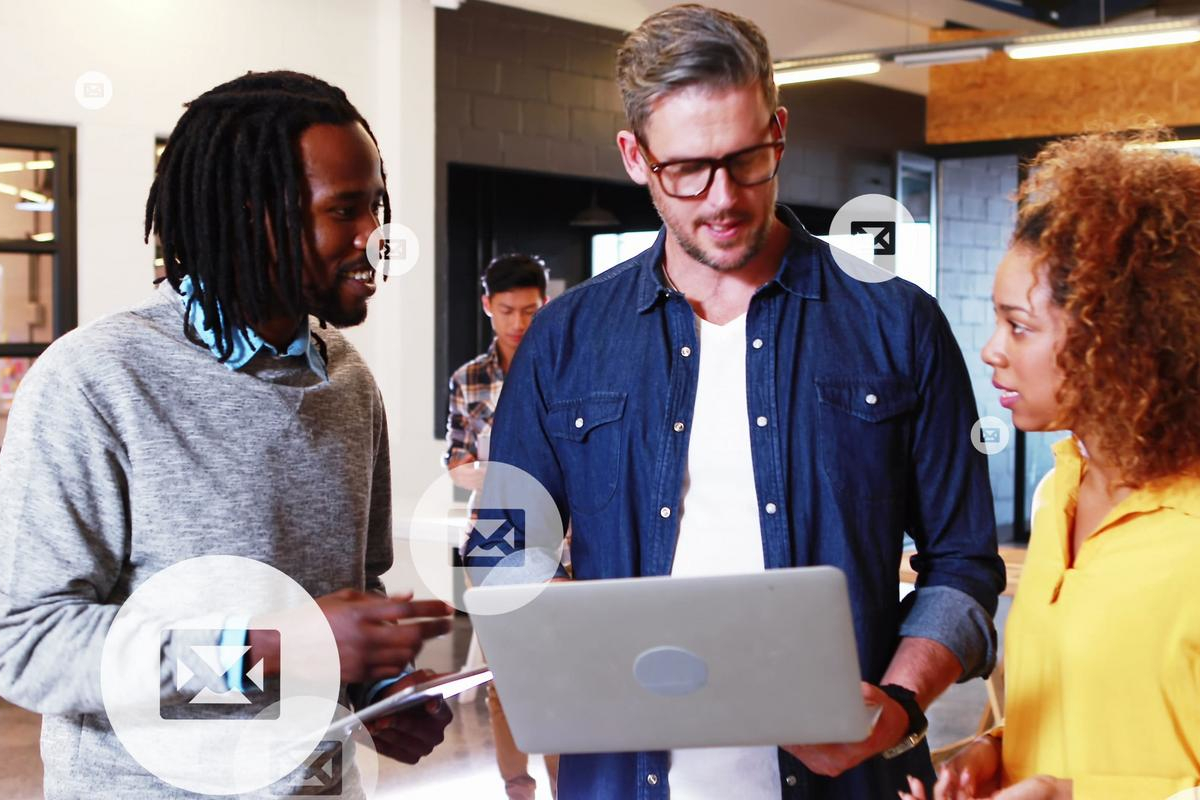 Coworkers reviewing an email together on a laptop