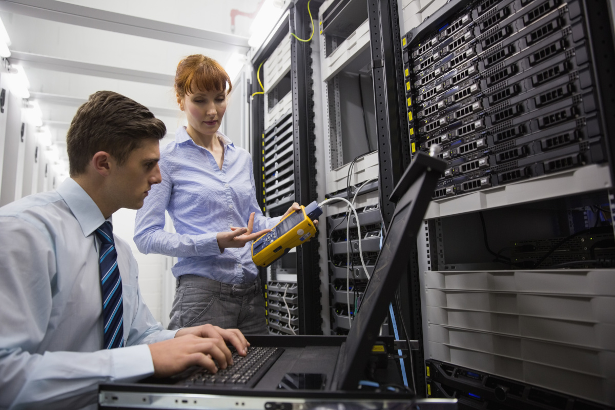 Two technicians working in a server room