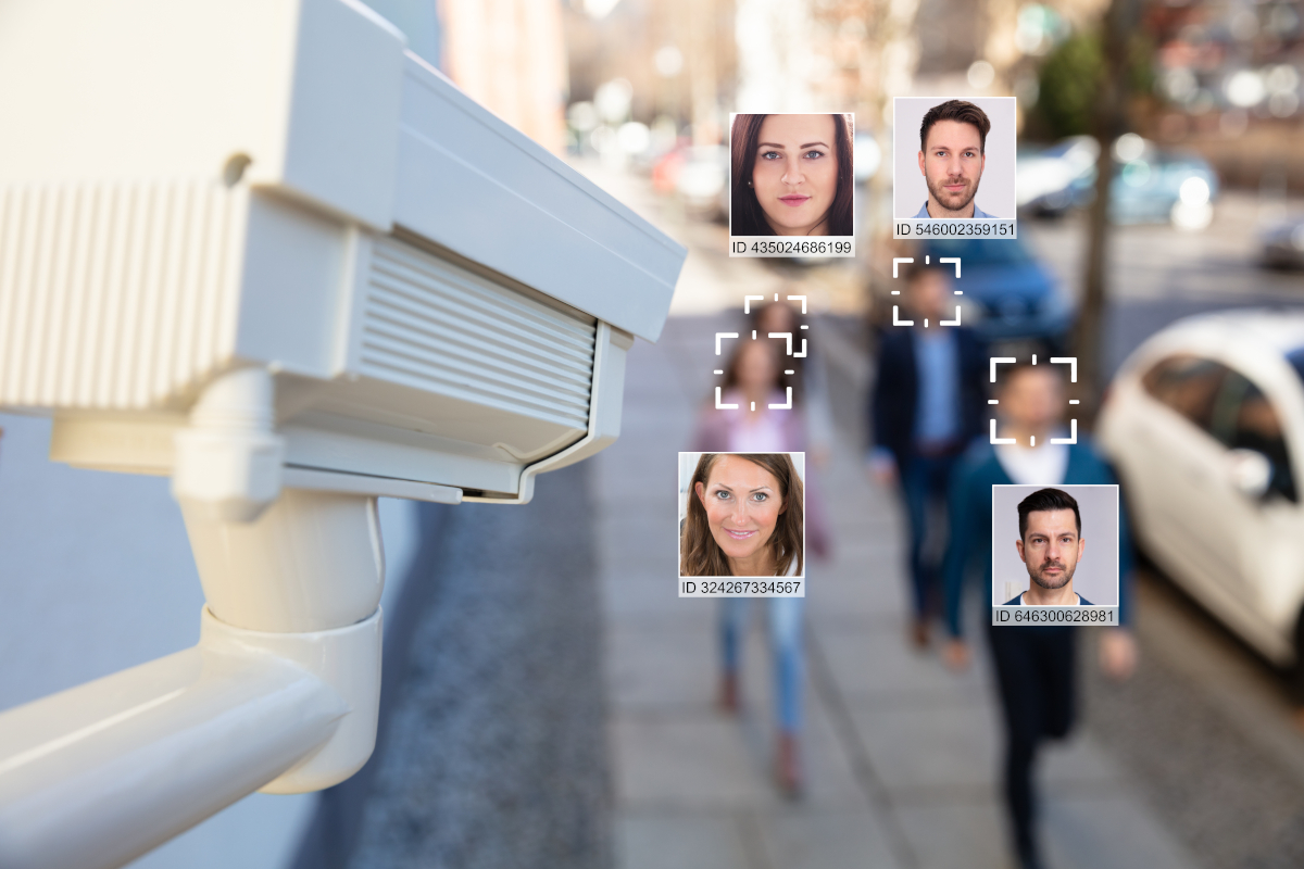 A security camera identifying the faces of a group of people walking by it.