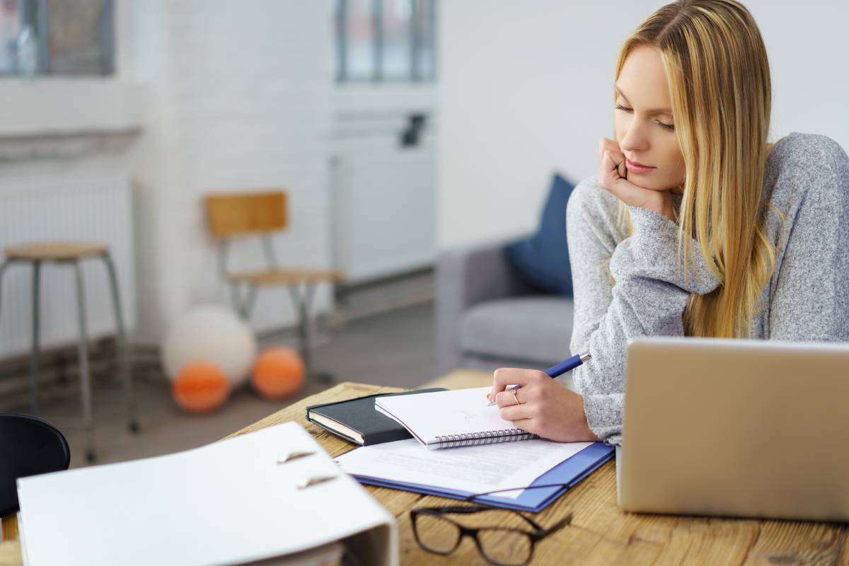 Blonde woman working remotely at her desk