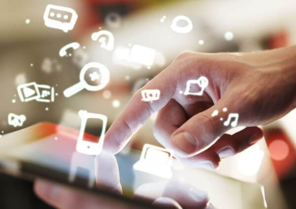 Hand interacting with digital touch screen, stylized icons floating about